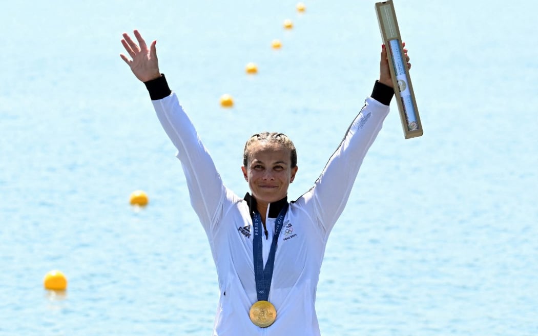 New Zealand's gold medallist Lisa Carrington celebrates on the podium during the medal ceremony after the women's kayak single 500m final of the canoe sprint competition at Vaires-sur-Marne Nautical Stadium in Vaires-sur-Marne during the Paris 2024 Olympic Games on August 10, 2024. (Photo by Bertrand GUAY / AFP)