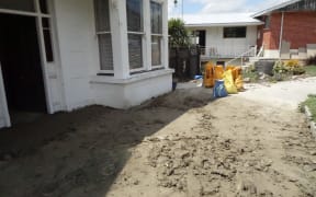 Sandbags being filled from Sunday's silt dump in case of another downpour.