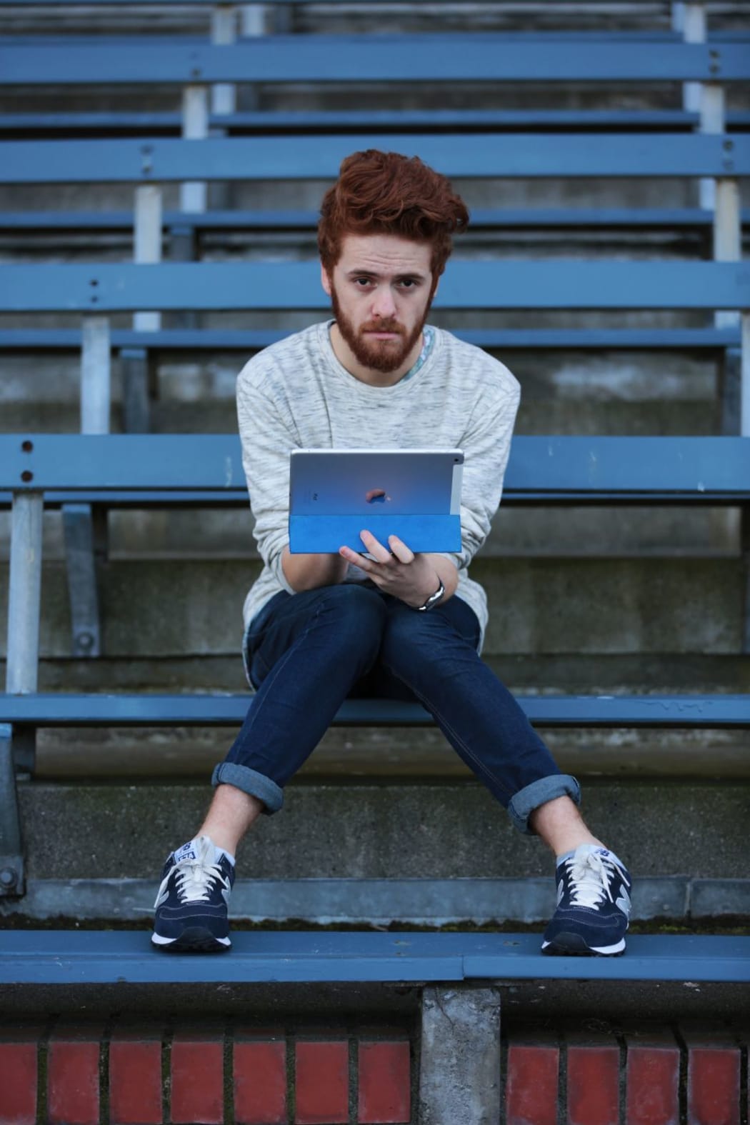 A shot of Henry Cooke holding an iPad
