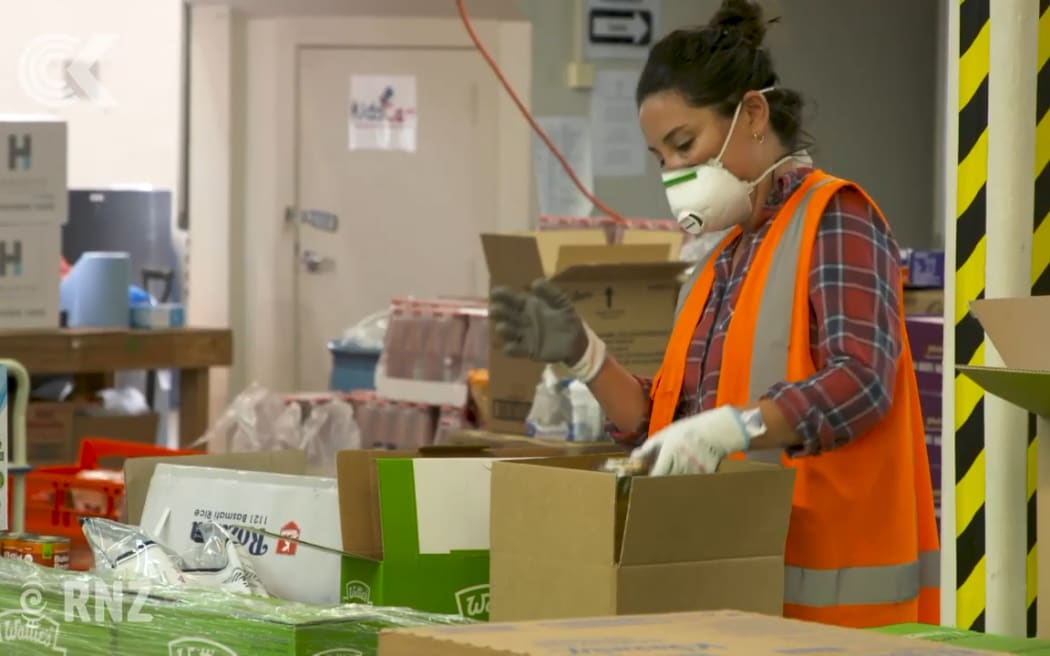 KidsCan workers fill boxes to deliver to families in need under lockdown.