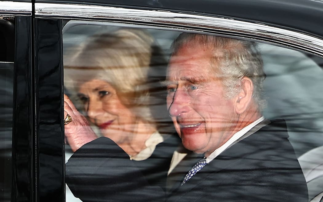 Britain's King Charles III and Britain's Queen Camilla wave as they leave by car from Clarence House in London on February 6, 2024. King Charles III's estranged son Prince Harry reportedly arrived in London on Tuesday after his father's diagnosis of cancer, which doctors "caught early". (Photo by HENRY NICHOLLS / AFP)