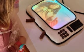 Neve watches Moana on her birthday cake