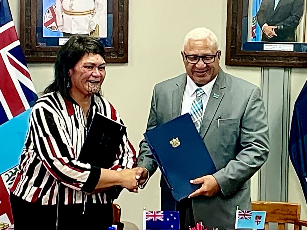 Fiji Prime Minister, Frank Bainimarama, and NZ Foreign Affairs Minister, Nanaia Mahuta, shake hands after signing the Duavata Partnership agreement in Suva, Fiji. 29 March 2022