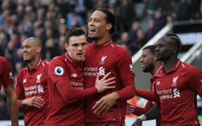Virgil van Dijk of Liverpool celebrates with his team-mates.