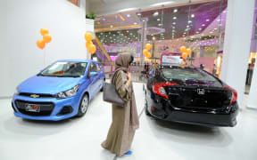Saudi women tour a car showroom for women.