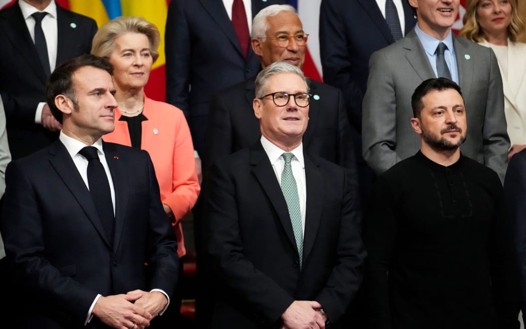 (From L) France's President Emmanuel Macron, Britain's Prime Minister Keir Starmer and Ukraine's President Volodymyr Zelensky pose for a family photograph during a summit held at Lancaster House in central London on March 2, 2025. European leaders descend upon London today for talks to "drive forward" action on Ukraine, according to the office of UK Prime Minister Keir Starmer. The summit caps off a week of intense diplomacy for host Starmer, who met with President Donald Trump on Thursday in an effort to draw together the European and US approaches to the Ukraine conflict. (Photo by Christophe Ena / POOL / AFP)