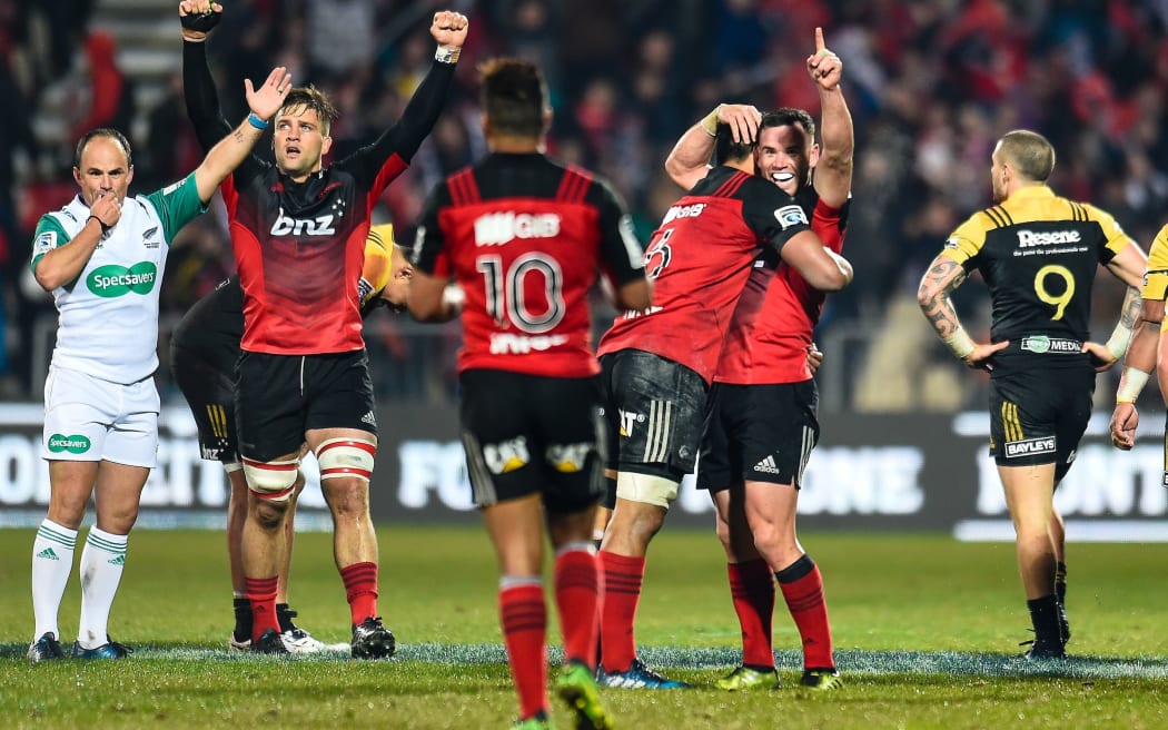 Crusaders players celebrate as full-time is called in the 20-12 win over the Hurricanes.