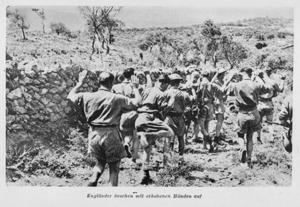 Allied soldiers being taken prisoner in Greece. The caption reads "Englishmen appear with hands raised"