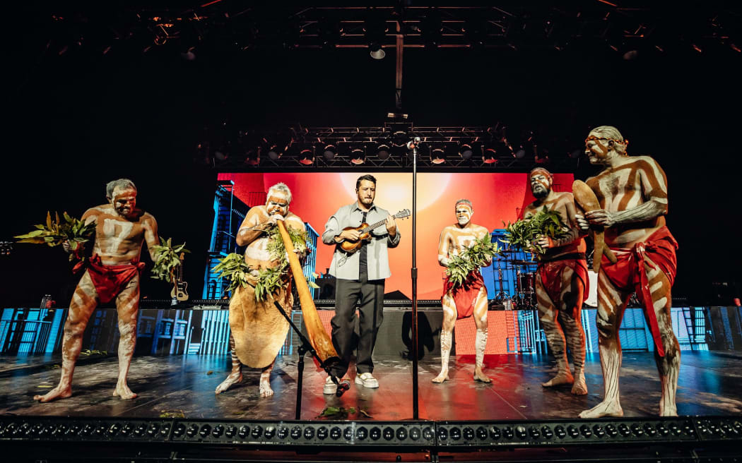 Members of the Nunukul Yuggera Aboriginal dance group on stage with Six60.
