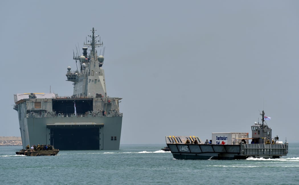 The Royal Australian Navy ship HMAS Canberra (L02) (C) and landing craft (R) take part in training excercise in the Sri Lankan capital Colombo on March 26, 2019.