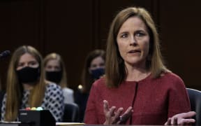 Supreme Court nominee Judge Amy Coney Barrett participates, with her family behind her, in the second day of her Senate Judiciary committee confirmation hearing on Capitol Hill on October 13, 2020 in Washington, DC.