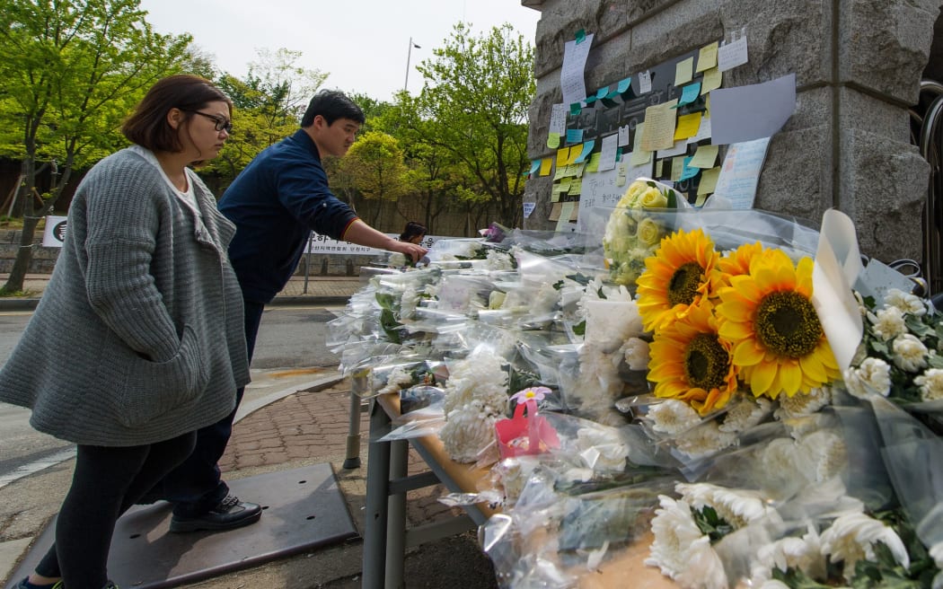 Flowers and messages have been left at the gates of Danwon high school.