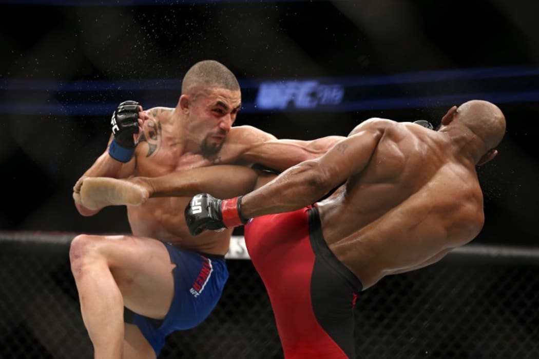 Robert Whittaker punches Yoel Romero in their interim UFC middleweight championship bout during the UFC 213 event.