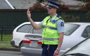 A police officer directs traffic at the intersection of Manukau and Greenlane Roads in Epsom.