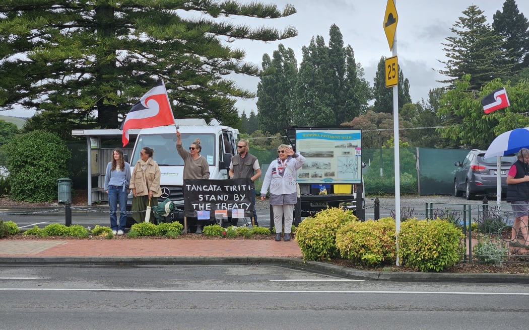 Supporters of the hīkoi mō te Tiriti wave to passing cars in Waipawa, Saturday November 16th 2024.