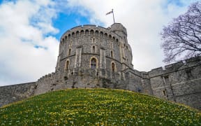 The Royal Standard flag, flown when Queen Elizabeth II is in residence, flies atop the Round Tower at Windsor Castle in Windsor, 31 March, 2022.
