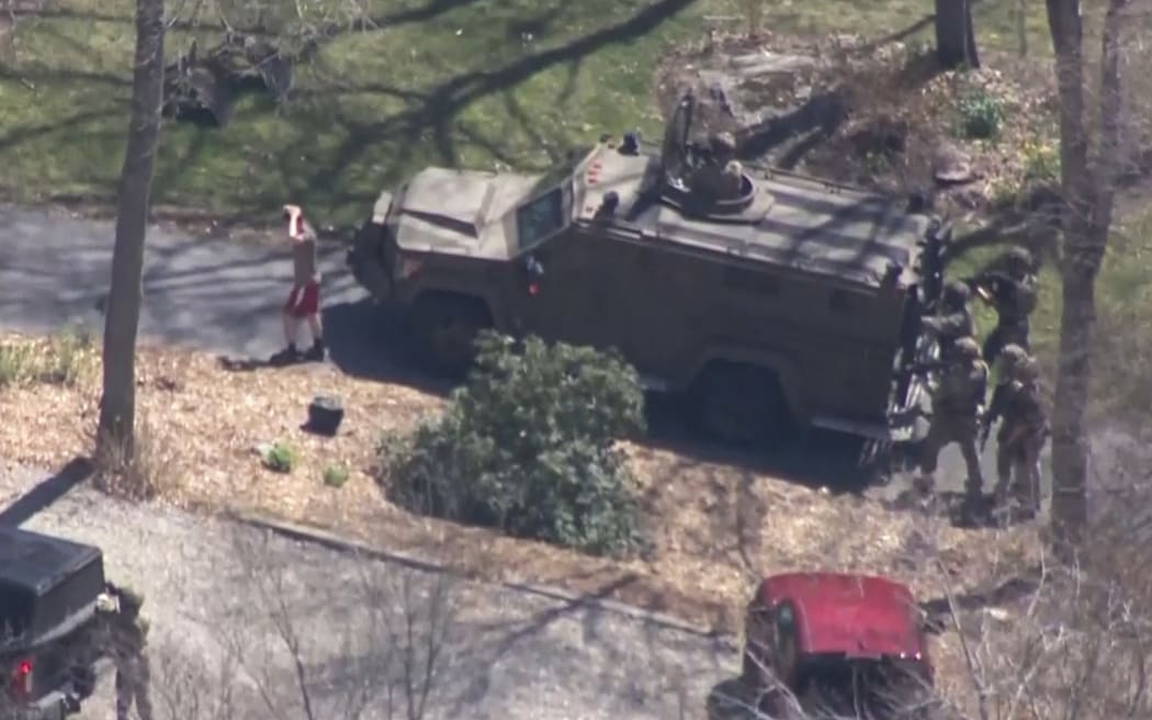 This aerial footage screen grab made from handout video released on April 13, 2023 by WBZ via CBS shows the suspect national guardsman Jack Teixeira taken into custody by FBI agents in a forested area in North Dighton, in the northeastern state of Massachusetts. - FBI agents arrested a young national guardsman suspected of being behind a major leak of sensitive US government secrets -- including about the Ukraine war. (Photo by WBZ via CBS / AFP) / RESTRICTED TO EDITORIAL USE - MANDATORY CREDIT "AFP PHOTO /  WBZ via CBS " - NO MARKETING - NO ADVERTISING CAMPAIGNS - DISTRIBUTED AS A SERVICE TO CLIENTS