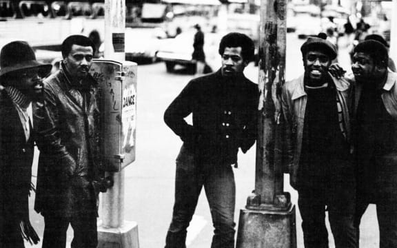 The Persuasions stand on a street corner