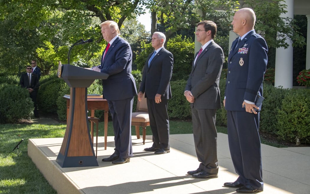 United States President Donald J. Trump, left, makes remarks establishing the US Space Command in the Rose Garden of the White House in Washington, DC on Thursday, August 29, 2019.