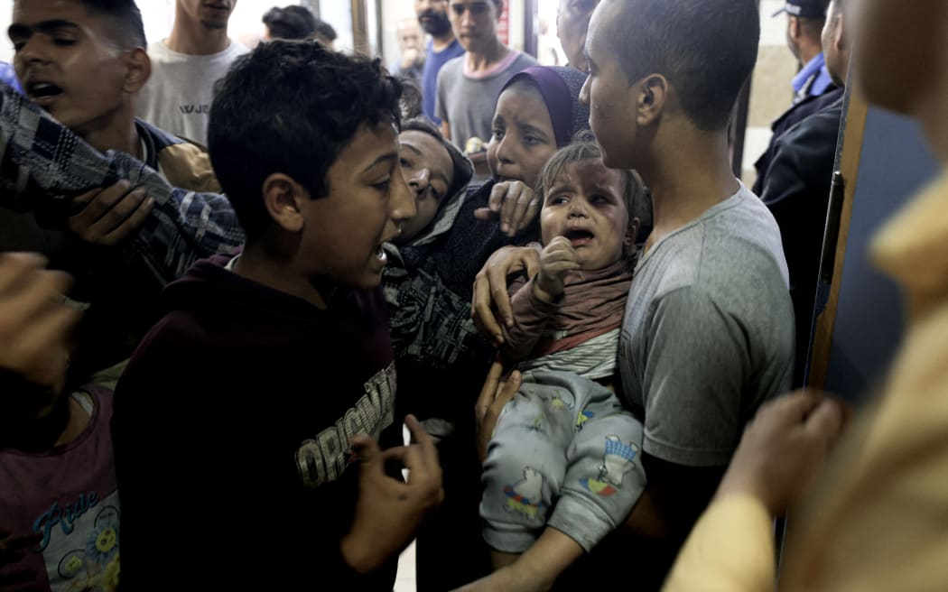 EDITORS NOTE: Graphic content / A wounded Palestinian child and other members of the Baraka family arrive at Nasser Hospital in Khan Yunis, following Israeli air strikes that hit their building in the southern Gaza Strip city on November 13, 2023. Israel is facing intense international pressure to minimise civilian suffering amid a massive air and ground operation that Hamas authorities say has already killed more than 11,000 people, including thousands of children. The military campaign came after Hamas fighters broke through the militarised border with Israel on October 7, killing around 1,200 people, mostly civilians, and taking about 240 people hostage, according to the most recent Israeli figures. (Photo by MAHMUD HAMS / AFP)