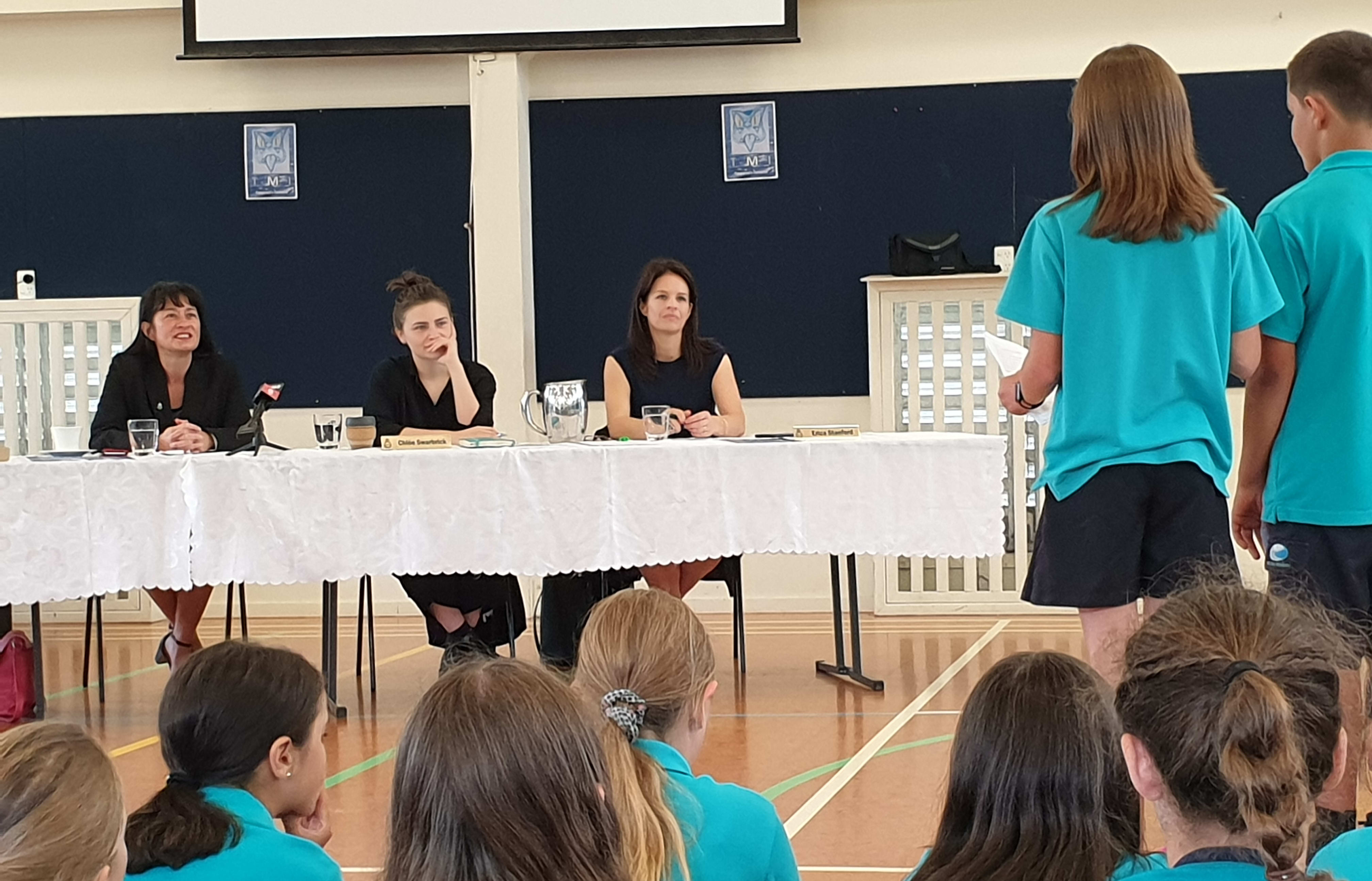 Labour Party MP Marja Lubeck, Green Party MP Chloe Swarbrick and National MP Erica Stanford listen earnestly to Long Bay Primary School year six students' petition.