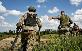 Servicemen of the 128th Separate Brigade of Territorial Defence Forces practise storming enemy positions during a tactical drill on 16 August 2023 in the Zaporizhzhia area, southeastern Ukraine.