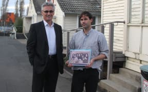 Qemajl Murati, manager of the Mangere Refugee Resettlement Centre and Murdoch Stephens, who holds a photo of a family from Afghanistan that he found in a refugee detention centre in Iran.