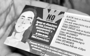 Cards with helplines being distributed to mark International Day for Elimination of Violence against Women in Auckland.