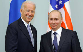 (FILES) In this file photo taken on March 10, 2011, Russian Prime Minister Vladimir Putin (R) shakes hands with US Vice President Joe Biden during their meeting in Moscow.