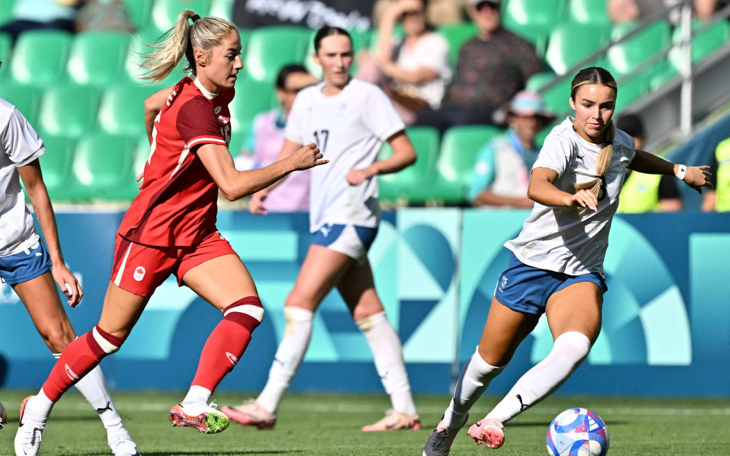 New Zealand's midfielder #08 Macey Fraser (R) and Canada's forward #16 Janine Beckie fight for the ball in the women's group A football match between Canada and New Zealand during the Paris 2024 Olympic Games at the Geoffroy-Guichard Stadium in Saint-Etienne on July 25, 2024. (Photo by Arnaud FINISTRE / AFP)