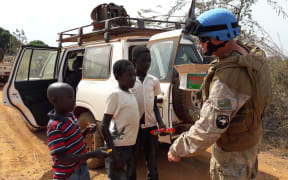 One of the New Zealanders on patrol with the UN Mission in South Sudan, talking and sharing treats with children near Juba.