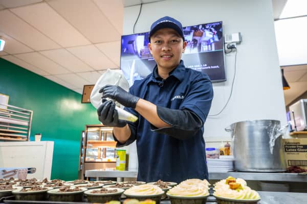 Samraksmey (Sam) So, owner of Rosedale Bakery & Café in Albany, holds a piping bag with his potato mix to top his mince pies.