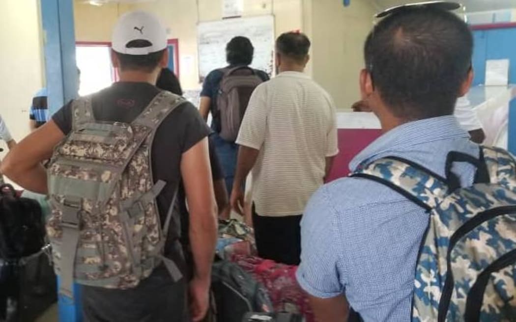 Manus Island refugees wait at the airport for their flight to Port Moresby.