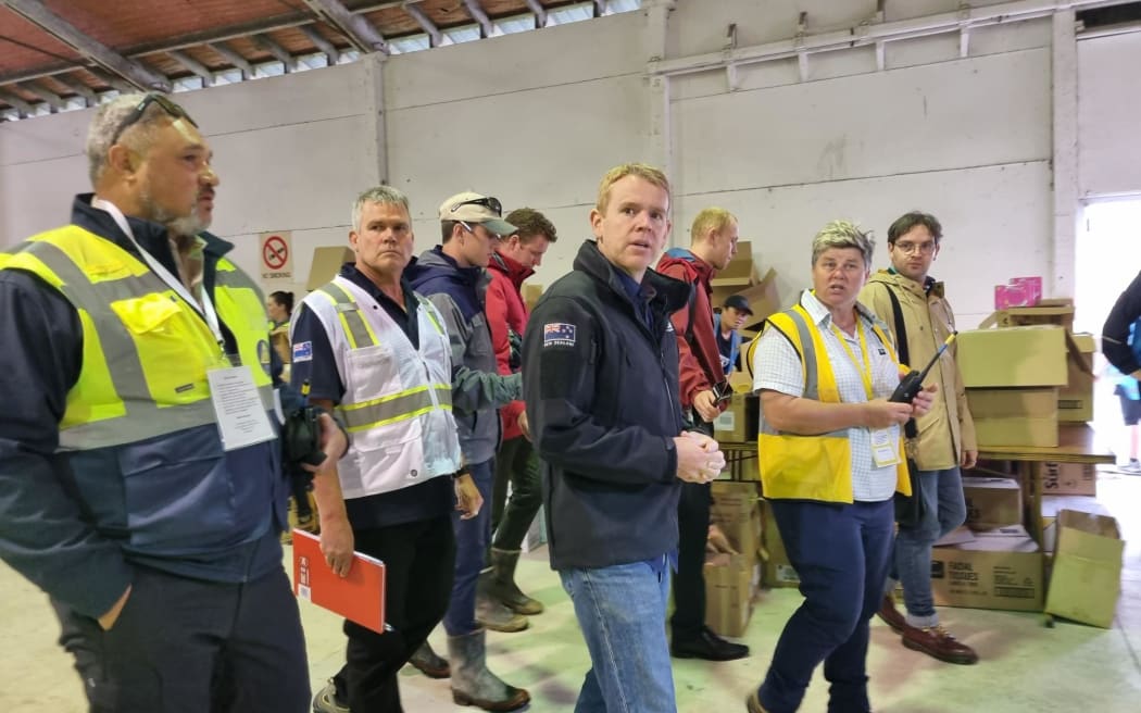 Hawke's Bay Regional Distribution Hub manager Kirsty Meynell shows Prime Minister Chris Hipkins around a warehouse full of goods for donation.