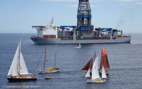 Greenpeace sponsored SV Vega confronts the Noble Bob Douglas drilling ship. Other yachts in the Oil Free Seas Flotilla say outside the 500 metre exclusion zone, from left, SV Tiama, SV Friendship, SV Shearwater II and SV Ratbag (brown sails).