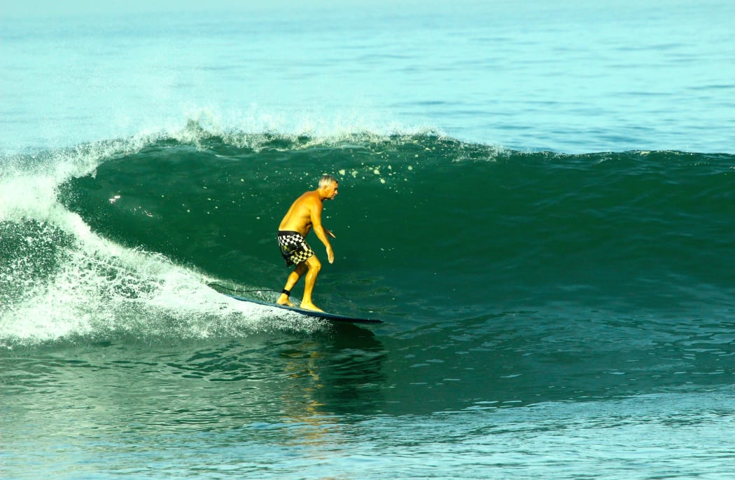 Phil Jarratt hits the waves. 10:30am
