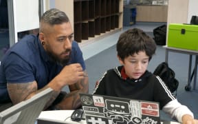 Ron Amosa (left) working with Davey (right) on a coding excercise.