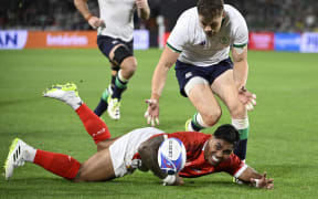 Ireland's centre Garry Ringrose (up) and Tonga's centre Malakai Fekitoa fight for the ball during the 2023 Rugby World Cup Pool B match between Ireland and Tonga at the Stade de la Beaujoire in Nantes, western France on 16 September, 2023.