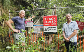 Austin Oliver and Angus Robson at the cordoned off entrance to a once popular walking track.