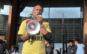 University of Waikato protestor Tawhanga Nopera speaking to the crowd with a megaphone on on 24 May, 2024.