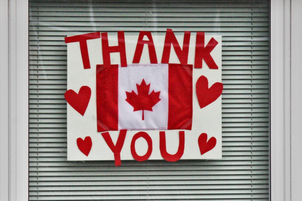 Canadian flag in the window of a home with the words 'thank you' as a show of appreciation to the frontline medical workers and all those working to protect Canadians from the novel coronavirus (COVID-19) in Toronto, Ontario, Canada on April 24, 2020.  (Photo by Creative Touch Imaging Ltd./NurPhoto)