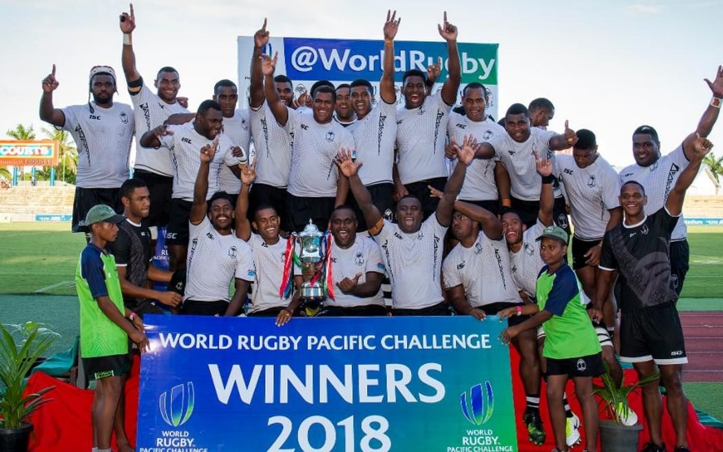 The Fiji Warriors celebrate with the trophy.