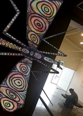 An Awhi Creature peeks at a patron in the Papakura Art Gallery.