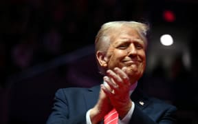 US President-elect Donald Trump reacts during a MAGA victory rally at Capital One Arena in Washington, DC, on January 19, 2025, one day ahead of his inauguration ceremony.