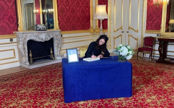 PM Jacinda Ardern signing the official condolence book for the Queen.