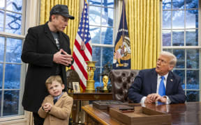 Tesla and SpaceX CEO Elon Musk with his son X Æ A-Xii join US President Donald Trump as he signs executive orders in the Oval Office of the White House in Washington, DC, February 11, 2025.