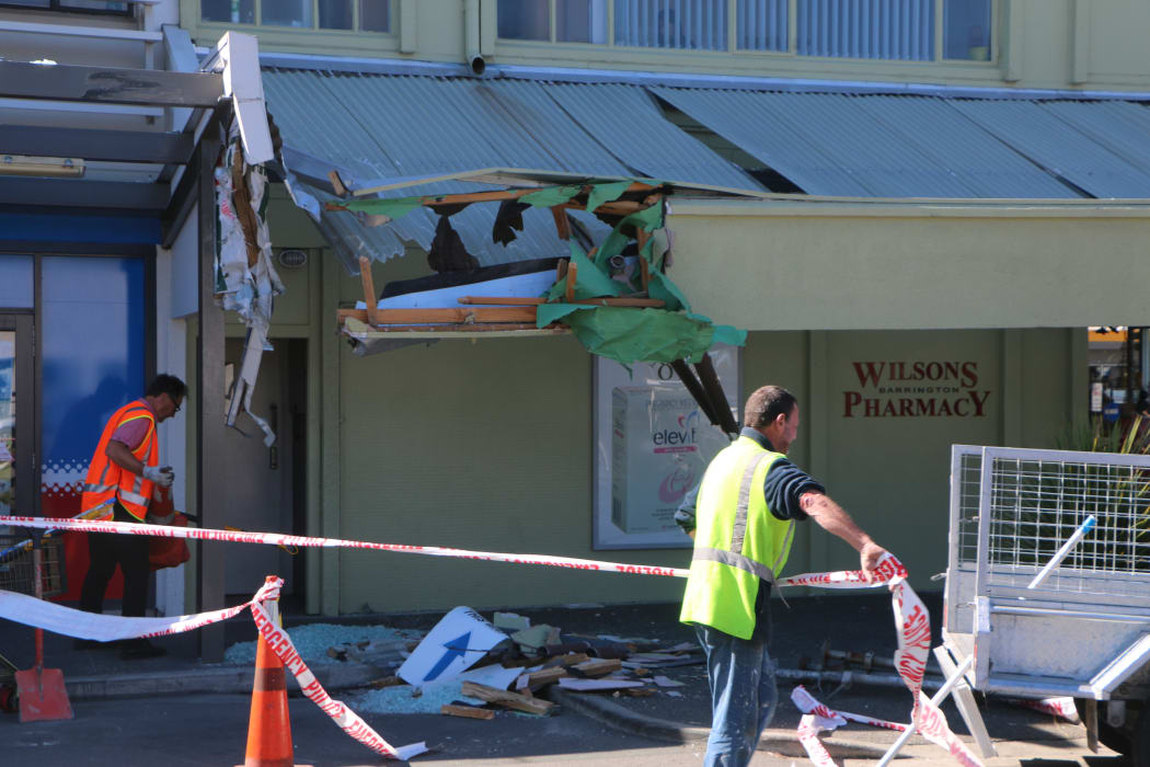 Crews cleaning up the area where a truck crashed into a shop on Barrington Street in Christchurch.