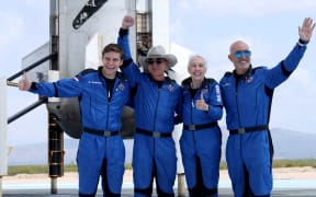 Blue Origins New Shepard crew (L-R) Oliver Daemen, Jeff Bezos, Wally Funk, and Mark Bezos pose for a picture near the booster after flying into space in the Blue Origin New Shepard rocket on July 20, 2021 in Van Horn, Texas.
