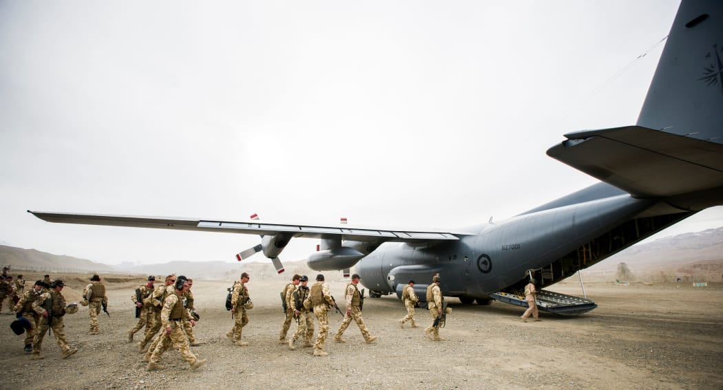 NZ Defence Force personnel boarding a Hercules plane.