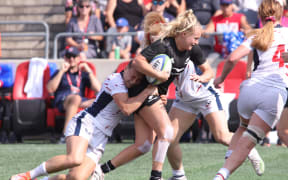 New Zealands Grace Steinmetz, centre, carries the ball.